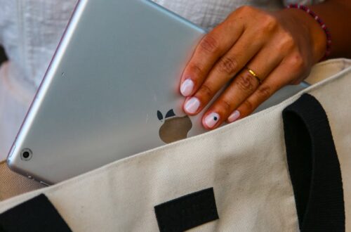 A Woman Hand Putting a Tablet in a Bag