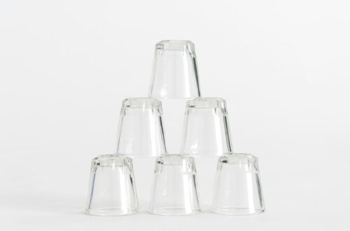 six piled clear shot glasses