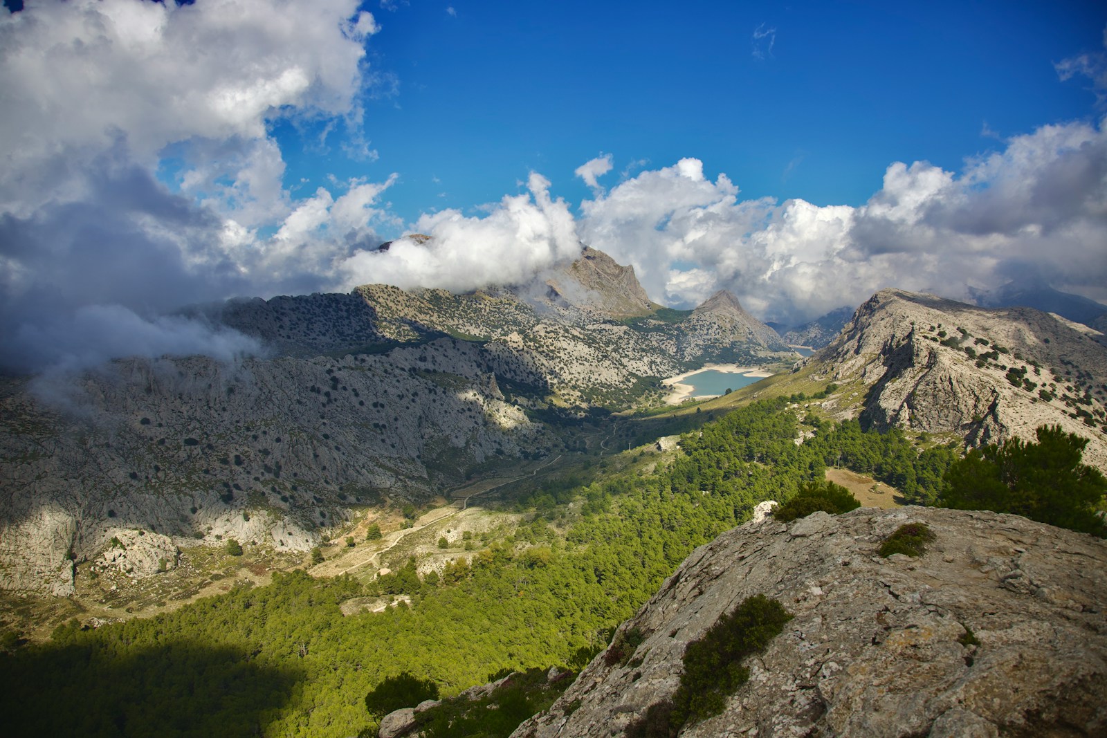 a view of a mountain range with clouds in the sky